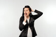 © Red Cristal - Sleepy young businesswoman, yawning with tired face, yawn from boredom, in black formal jacket white shirt, standing over white background. Business concept