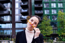 Playful Businesswoman Making Mustache With Pencil At Office Park