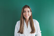 © Westend61 - Beautiful woman with brown hair against green background