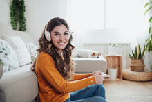Smiling Woman With Headphones Playing Game With Joystick