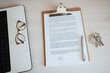 © Westend61 - Eyeglasses on laptop by contract document with pen and bunch of keys