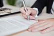 © Westend61 - Real estate agent signing document at office
