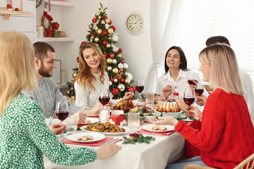 Wall Mural - Happy family with their friends enjoying festive dinner at home. Christmas Eve celebration