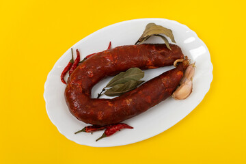 Sticker - typical smoked sausage chourico on white dish