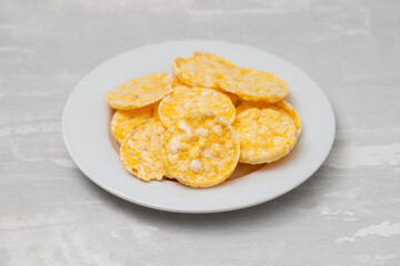 Sticker - small puffed corn cakes on small white plate