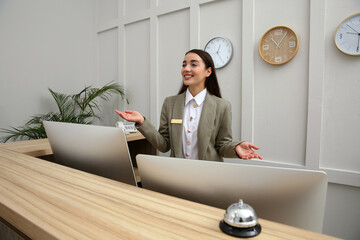 Poster - Beautiful receptionist working at counter in hotel