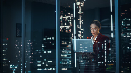 Poster - Successful Businesswoman in Stylish Suit Working, on Laptop Looking in Wonder at Night City. Stylish Beautiful Female CEO Working Late on Computer to Achieve Best Results. Colorful Portrait
