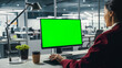 © Gorodenkoff - Successful Caucasian Businesswoman Sitting at Desk Working on Green Screen Laptop Computer in Office. Beautiful Businessperson using Chroma Key Display. Over the Shoulder Shot