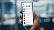 © Gorodenkoff - Black Businessman Holding Smartphone with Social Media App in Office. African-American Businessperson using Internet, Social Media with Mobile Phone Device. Over Shoulder Shot