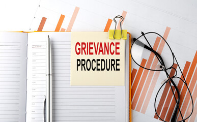 Poster - Text GRIEVANCE PROCEDURE on sticker on the notepad on diagram background