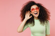 © ViDi Studio - Curious nosy jubilant fun young curly latin woman 20s years old wear mint t-shirt sunglasses try to hear you overhear listening intently isolated on plain pastel light pink background studio portrait