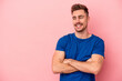 © Asier - Young caucasian man isolated on pink background smiling confident with crossed arms.