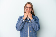 Young Caucasian Woman Isolated On Blue Background Shocked Covering Mouth With Hands.