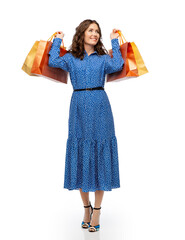 Wall Mural - fashion, sale and people concept - happy smiling beautiful young woman posing in blue dress with shopping bags over white background