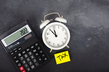 Wall Mural - Tax time. Tax and finance concepts. alarm clock, dollar and tax text.