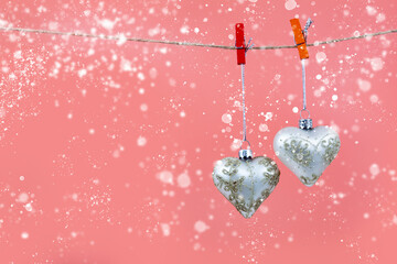 Wall Mural - Christmas balls hearts on a pink background.