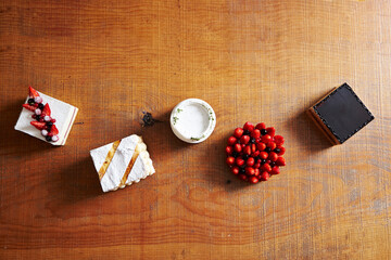 Sticker - Assorted cakes on wooden table background