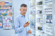 © zinkevych - A man choosing medicines in a drugstore