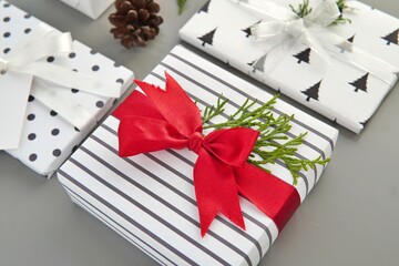 Cloe up view of Christmas gift box with red bright ribbon, holiday season, gifts wrapping concept.