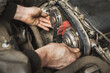 A person independently changes the timing belt in a passenger car