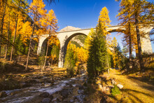 Railway Bridge Over An Alpine Stream And Autumn Landscape, Graubunden, Switzerland