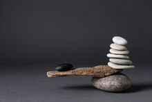Stones With Tree Branch On Black Background. Harmony And Balance Concept
