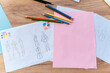 © NFstock - Designer's desk with different tools and sketches. Top view of the drawing sketches of the future collection of clothes