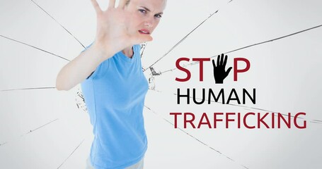 Wall Mural - Animation of stop human trafficking text over caucasian woman with stop gesture