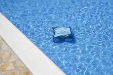 Cleaning The Pool Floor With An Underwater Vacuum Cleaner, Pool Maintenance Concept.