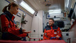 © stockbusters - Team of paramedics driving on emergency call inside ambulance car