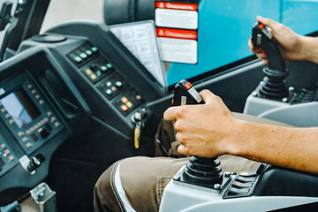 Close-up of a hand holding a joystick to control a crane.Construction concept