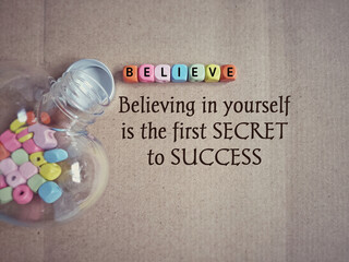 Wall Mural - Inspirational and motivational quote of believing in yourself is the first secret to success. Text in vintage background. Stock photo.