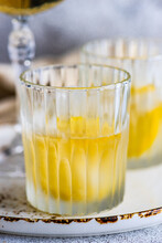 Two Glasses Of Vodka Cocktails With Lemon And Ice Cubes On A Table