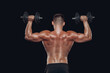 © satyrenko - Close up back view of muscular body and strong hands lifting heavy dumbbells isolated over black background