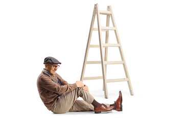 Sticker - Elderly man sitting on the floor next to a ladder holding his hurt knee