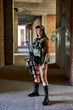 © Roman - military fashion woman with rifle with an optical sight. Army female with weapon in abandoned building, posing, looking at side smiling, defender in military wear gear alone. military forces concept