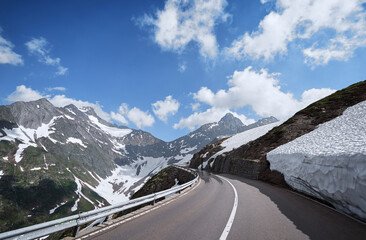 Asphalt road in Alp mountains. Road trip concept. Beautiful landscape.