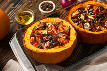 Baking Dish With Tasty Stuffed Pumpkins On Wooden Background, Closeup