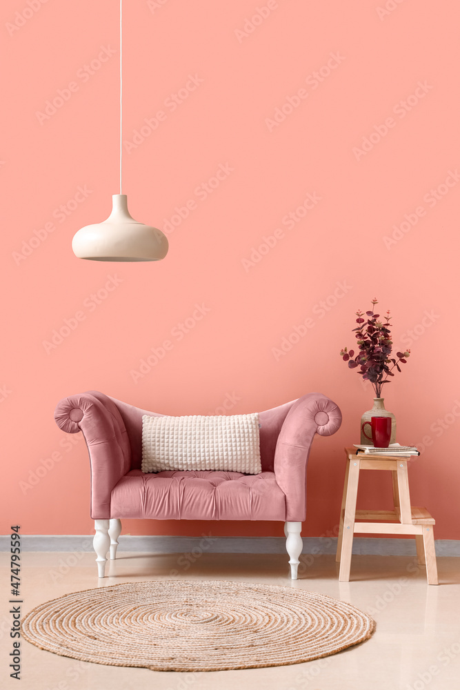 Stylish comfortable armchair near pink wall in room