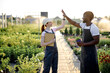 © Roman - Male and female multiracial engineers give high five to each other after successful inspecting greenhouse organic farm business construction. Multi-sex farmers. Man and woman. Agronomy concept