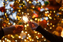 Two Hands With Sparklers On A Christmas Or New Year's Eve Background