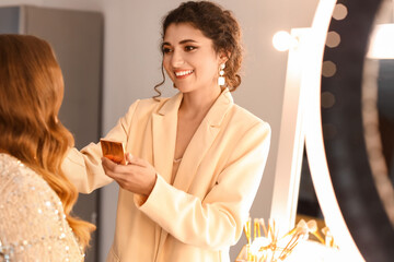 Canvas Print - Makeup artist working with beautiful model in beauty salon