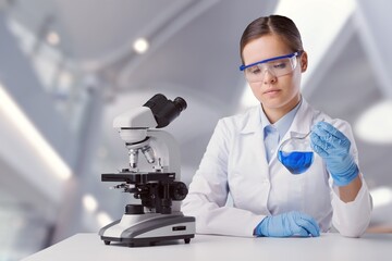 Wall Mural - biotechnologist scientist researching with a microscope in pharma lab. modern laboratory