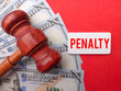 Phrase penalty written on wooden board with gavel and fake money. Law concept.