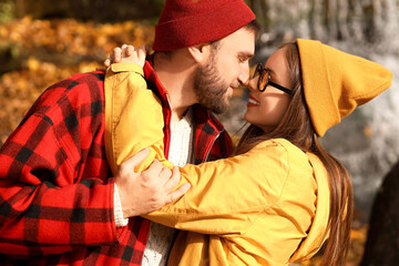 Wall Mural - Happy loving couple hugging on sunny autumn day