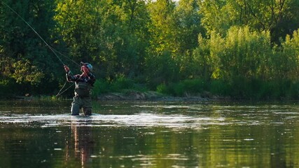 Wall Mural - Fly fishing. Man fly fishing on the wild river with lots of insects flying in the air