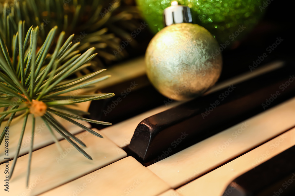 Piano keys with fir branch, closeup