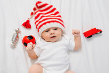 Cute Little Kid In Cap Of Christmas Elf Or Gnome. Baby Santa Claus