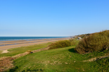 The end of Omaha beach in Europe, France, Normandy, towards Arromanches, Colleville, in spring, on a sunny day.