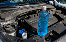 Automobile Maintenance. Filling The Windshield Washer Fluid On A Car